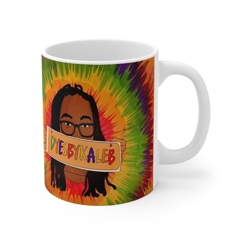 a coffee cup sitting on top of a table next to a cup