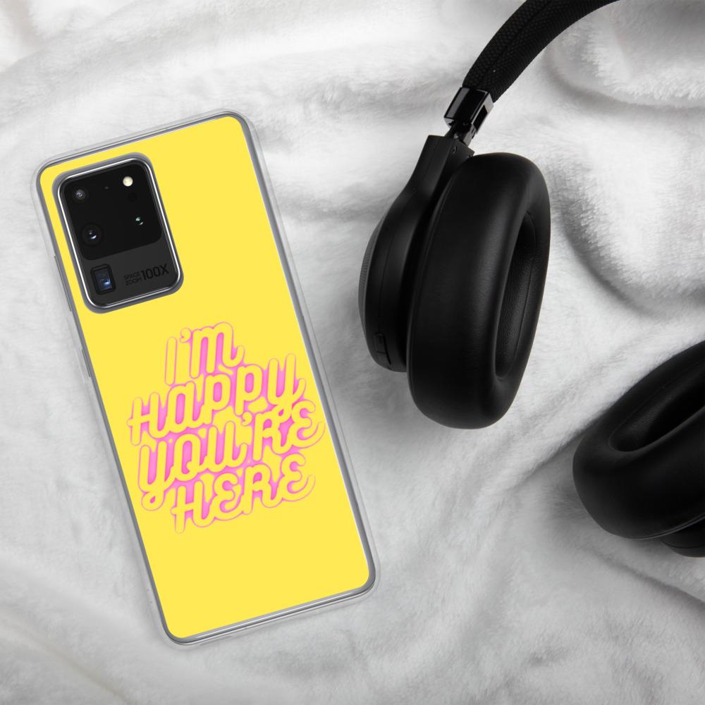 a yellow cell phone sitting on top of a bed 